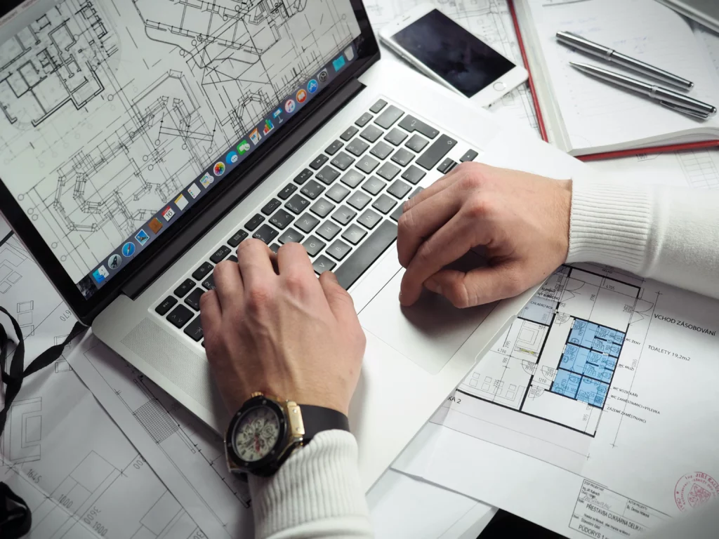 Construction professional examining a floorplan on a computer using QuikQuote's quantity takeoff features